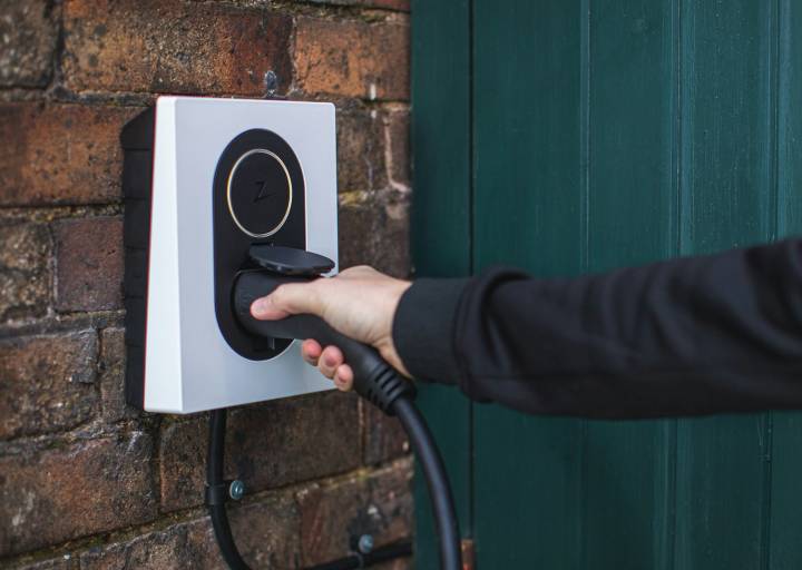 a person is plugging in to a wall mounted device