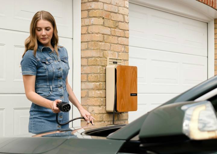 A woman is standing next to a car